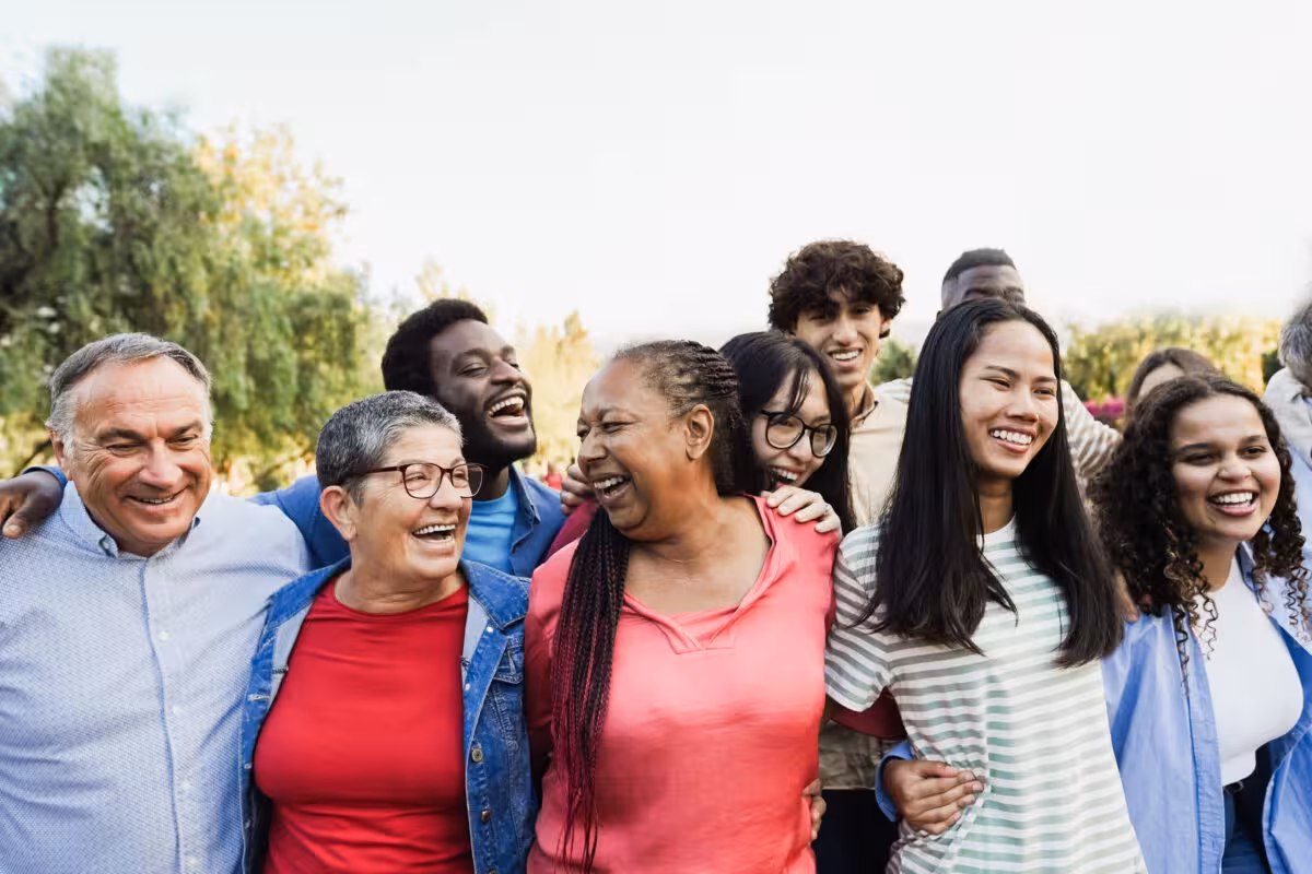 Diverse Group People Various Ages Ethnicities Laughing Together A diverse group of people of various ages and ethnicities laughing together outdoors.