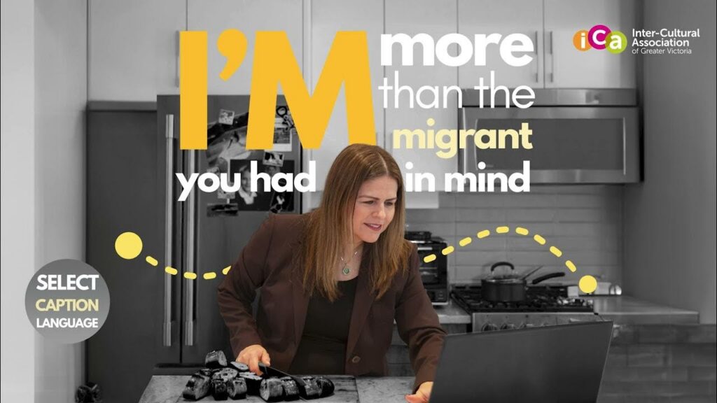 A woman is looking at a laptop in a kitchen with text that reads "I'm more than the immigrant you had in mind".