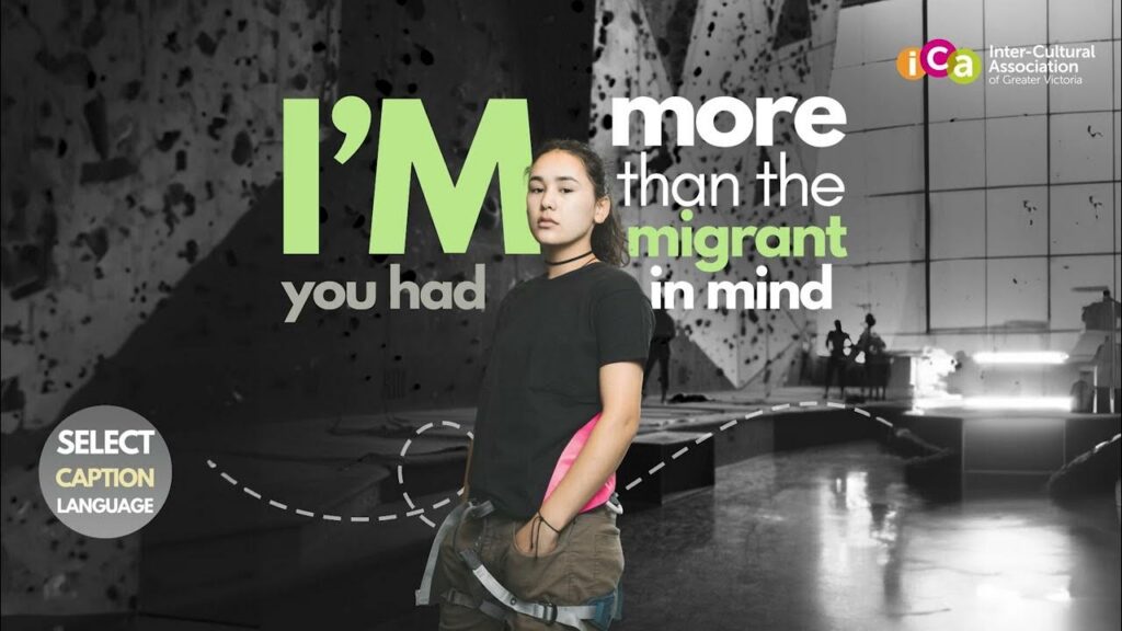 A young woman stands in front of text that reads "I'M more than the immigrant in mind".