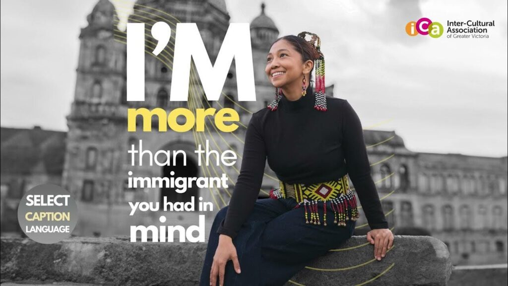 A woman with decorative earrings and belt sits in front of a blurred building and text that reads "I'm more than the immigrant you had in mind".